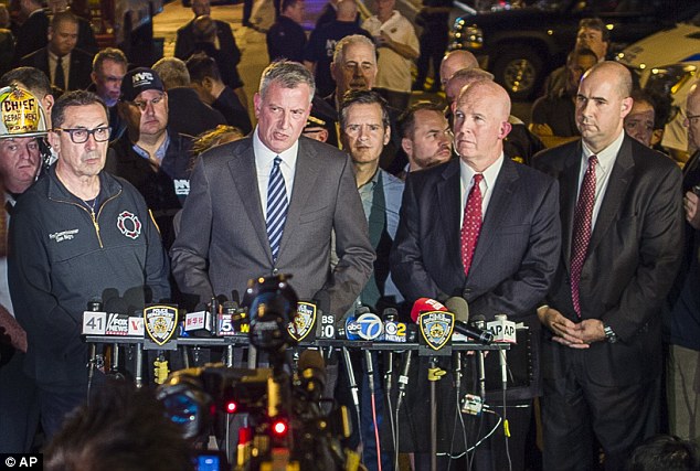 Mayor Bill de Blasio, center, and NYPD Chief of Department James O'Neill, center right, speak during a press conference near the scene of an apparent explosion on West 23rd street in Manhattan's Chelsea neighborhood, in New York on Saturday